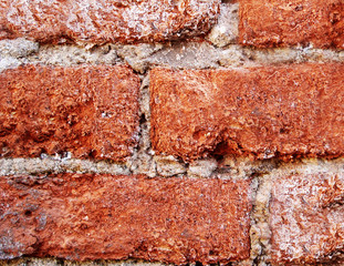 Red brick corroded by corrosion and time.