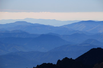 Blue ridges in central part of Low Tatra National Park, around Certovica Pass, with Slovak Central Mountains in the background, from Lomnicky peak, High Tatras, Slovakia, Europe