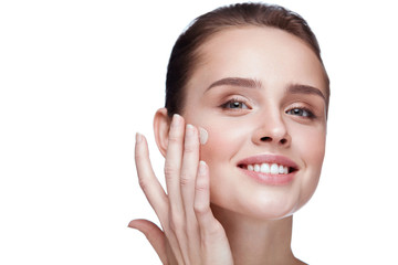 Cosmetics. Beautiful Girl Applying Cream On Face. Beauty Makeup