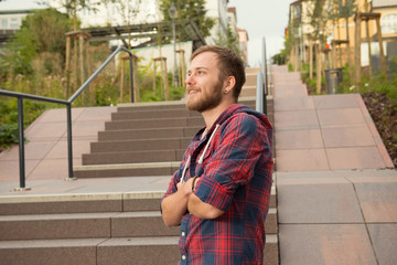 young man standing in the city on stairs