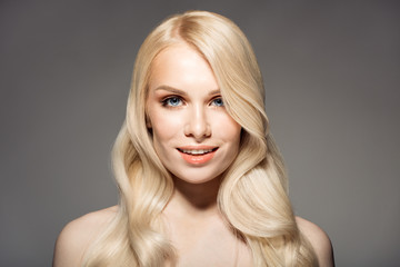 Portrait Of Beautiful Young Blond Woman With Long Wavy Hair.