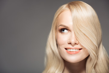 Naklejka premium Portrait Of Beautiful Young Blond Woman With Long Wavy Hair.
