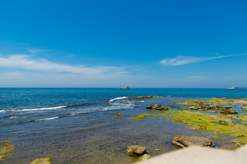 Fototapeta na wymiar Seascape with waves, reefs and ship
