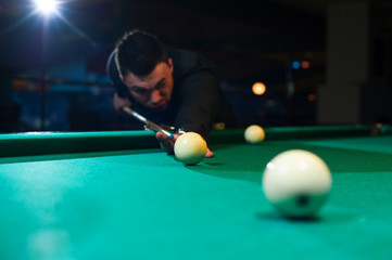 Cropped shot of male adult playing billiard game.