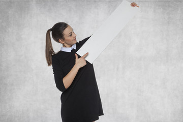 Beautiful girl points to your advertisement