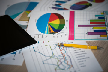 Digital tablet and financial report on table
