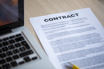 Contract document and lap top