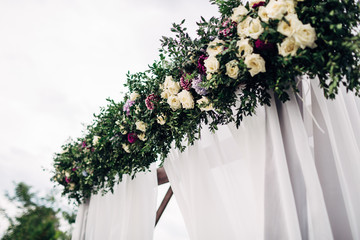 The different flowers hanging on the archway
