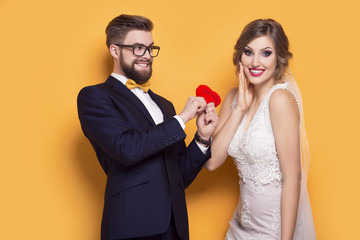 Young couple holding red heart