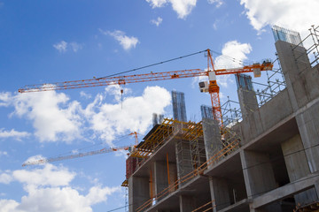 Building cranes and buildings on  background cloudy sky
