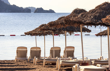 Deck chairs and umbrellas on beach in Marmaris, Turkey