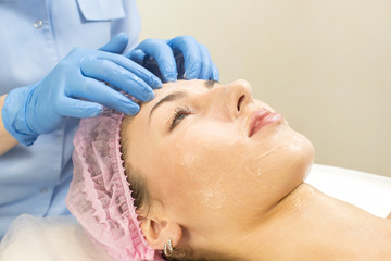 Fototapeta na wymiar Process cosmetic mask of massage and facials in beauty salon 