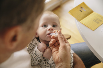 Three-month-old baby receiving oral vaccination