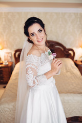 The bride keeping a buttonhole for groom