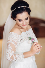 The bride keeping a buttonhole for groom