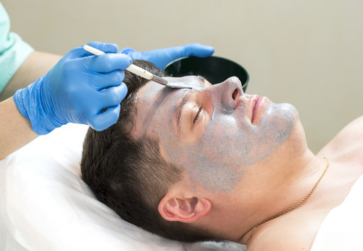 Man in the mask cosmetic procedure in spa salon