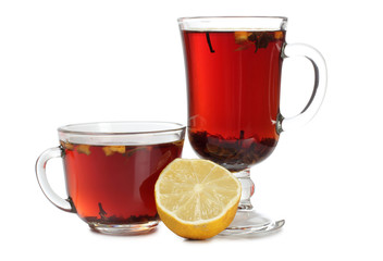 Glass cup with tea and lemon on white background