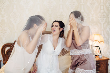 The bride and bridesmaids smiling to each other