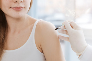 Qualified doctor treating teenager in the clinic