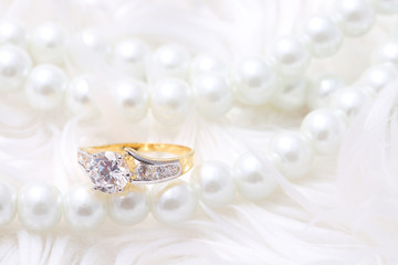 Golden ring with diamond and pearl