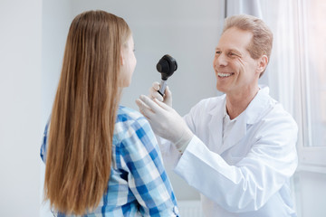 Happy doctor using special equipment in the clinic