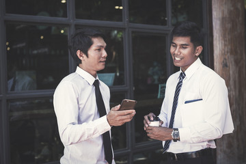 businessman talking and play phone after rest time at cafe