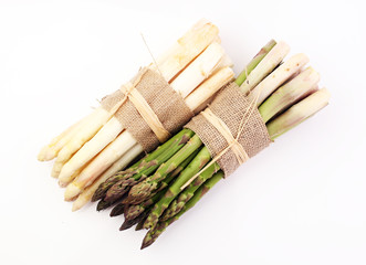 Bunch of fresh white asparagus and green asparagus on table