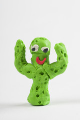 Cute plasticine cactus. Isolated on white background
