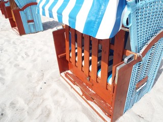 Preseason at the Baltic Sea -
Partial view of a blue beach basket on a sand beach.

