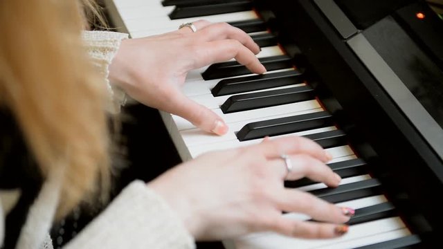 A talented pianist plays a synthesizer at a concert