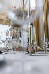 Fototapeta na wymiar Crystal wineglasses stand side by side on the dinner table