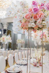 Elegant tall vase with roses and orchids