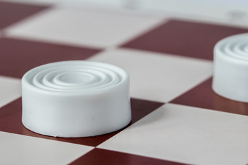 White checkers close-up on gaming board