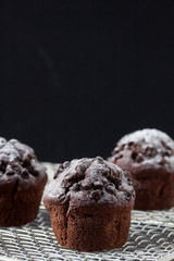 chocolate muffin, pouring powdered sugar
