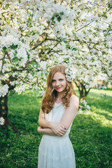 Fototapeta na wymiar A girl in a blooming garden