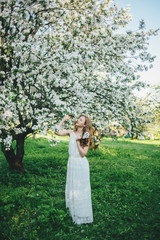 Obraz premium A girl in a blooming garden