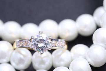 Golden ring with diamond and pearl