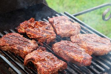 Meat steaks on the grill