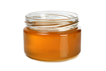 Glass jar with honey on a white background