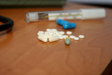 Tablets with a thermometer on the table