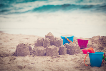 Fototapeta na wymiar kids toys and sandcastle on beach