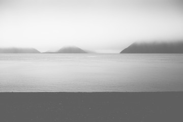 Rain Storm on Calm Alaska Fjord with Foggy Skies 