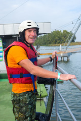 Joyful wakeboarder after successful performing a trick