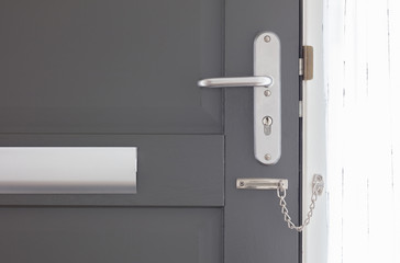 Door chain on a grey door