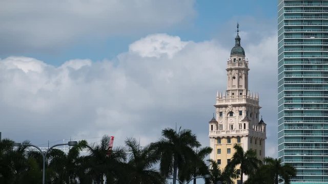 Time lapse of church and skyscraper with clouds on the background