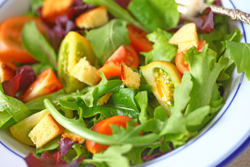 Mixed greens salad with miniature heirloom tomatoes and croutons