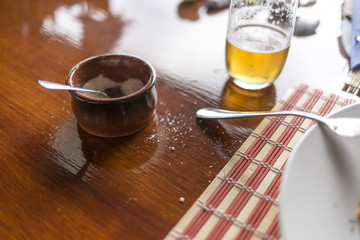 Salt pot and beer glass wooden table