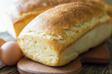 bread baked in the oven and eggs on the table
