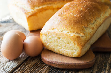 bread baked in the oven and eggs on the table