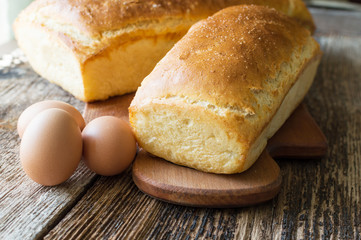 bread baked in the oven and eggs on the table